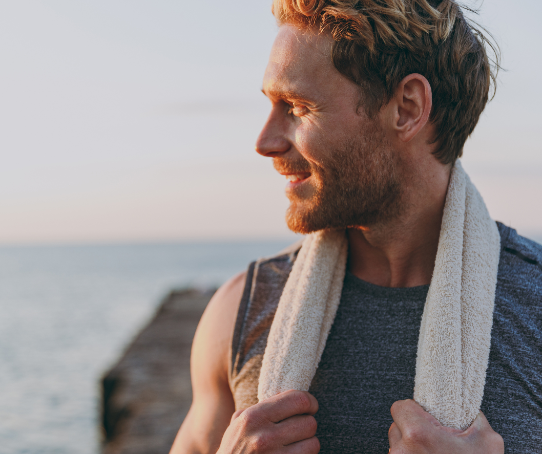 A man looking into the horizon, thinking what male skincare routine he should be choosing
